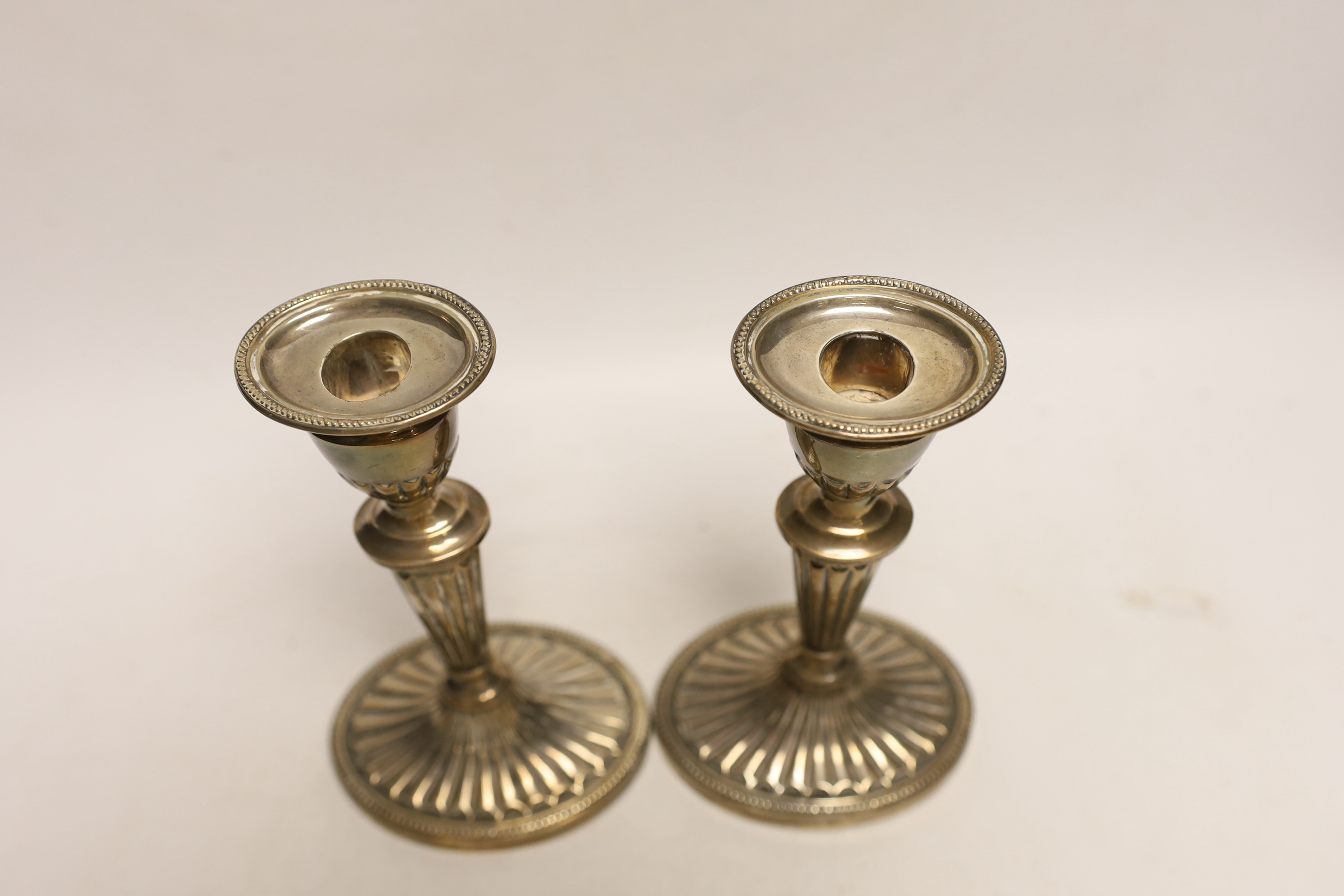 A pair of Edwardian silver mounted oval candlesticks, Barnett Henry Abrahams, Birmingham, 1908, 18.2cm, weighted.